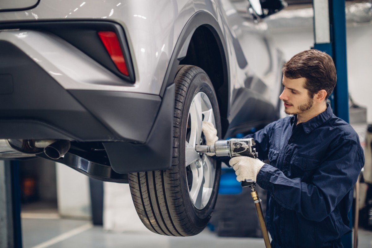 mechanic working on car tire 