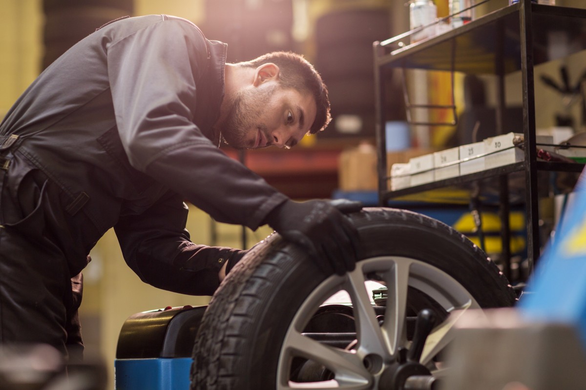 technician inspecting the tire and rim