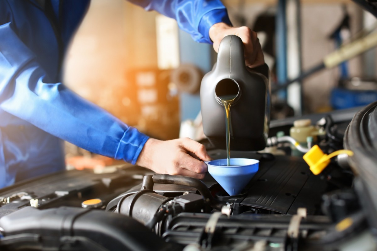 oil being poured into a funnel