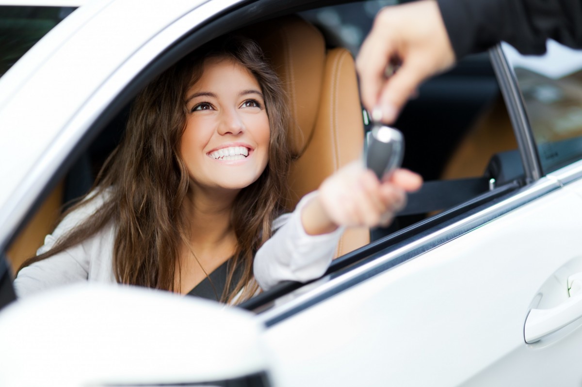 man handing girl car keys