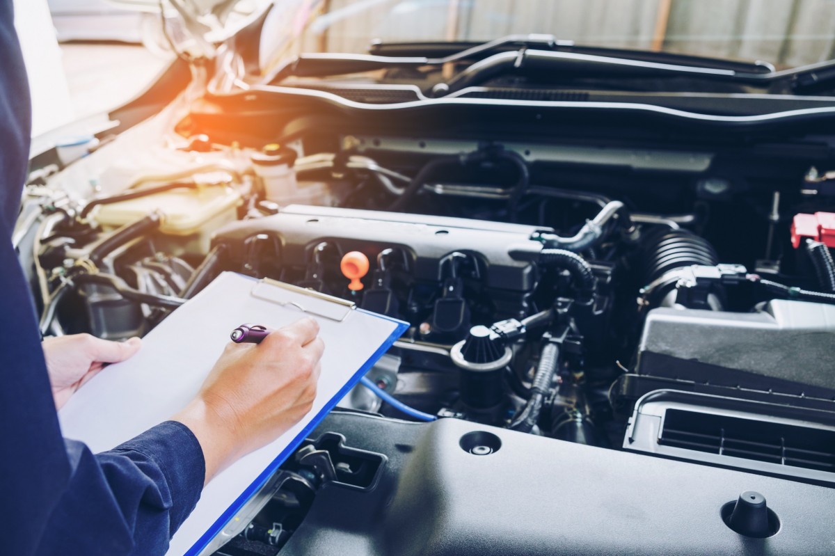 mechanic holding a clipboard with a checklist